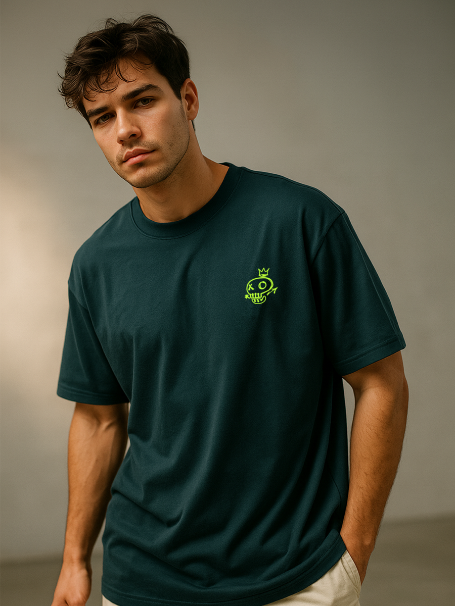 Man wearing a bottle green t-shirt with a logo on a plain background